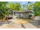 Charming single story home with a light grey exterior, inviting front porch, and well maintained landscaping at 1150 Kennesaw Due West Nw Rd, Kennesaw, GA 30152