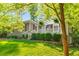 A well-manicured lawn leads to a cozy porch with decorative accents, enhancing the home's inviting facade at 1150 Kennesaw Due West Nw Rd, Kennesaw, GA 30152