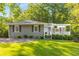 Charming home with a covered front porch, lush lawn, and well-maintained landscaping creates curb appeal at 1150 Kennesaw Due West Nw Rd, Kennesaw, GA 30152