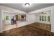 The kitchen features stainless steel appliances and a breakfast bar, seamlessly connecting to the living room at 1150 Kennesaw Due West Nw Rd, Kennesaw, GA 30152