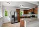Modern kitchen featuring stainless steel appliances, granite countertops, and wooden cabinetry at 1150 Kennesaw Due West Nw Rd, Kennesaw, GA 30152