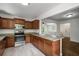 Well-lit kitchen with stainless steel appliances, granite countertops, and dark wood cabinets at 1150 Kennesaw Due West Nw Rd, Kennesaw, GA 30152