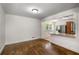 Bright living room showcases refinished hardwood floors and an open layout to the kitchen at 1150 Kennesaw Due West Nw Rd, Kennesaw, GA 30152