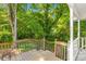 View of a wooden deck porch with stairs and railing looking out to the backyard at 1150 Kennesaw Due West Nw Rd, Kennesaw, GA 30152