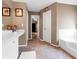 Bathroom featuring a white vanity, tub, and neutral-toned walls at 245 Vaness Dr, Mcdonough, GA 30253