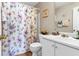 Traditional bathroom with a floral shower curtain and white sink at 245 Vaness Dr, Mcdonough, GA 30253