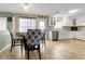 Open dining area with tile flooring connecting to a modern kitchen at 245 Vaness Dr, Mcdonough, GA 30253