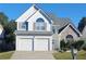 Charming two-story home with a two-car garage, stone accents, and well-maintained landscaping at 245 Vaness Dr, Mcdonough, GA 30253