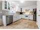 Bright and airy kitchen with white cabinets, stainless steel appliances and granite countertops at 245 Vaness Dr, Mcdonough, GA 30253
