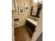 Bathroom with double sinks, dark cabinetry, and wood-look floors at 3753 Soapstone Rd, Decatur, GA 30034