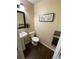 Bathroom featuring a pedestal sink, modern toilet, and wood-look tile flooring at 3753 Soapstone Rd, Decatur, GA 30034