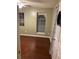 A cozy bedroom with hardwood floors, two windows, and neutral wall color at 3753 Soapstone Rd, Decatur, GA 30034