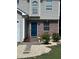 Charming two-story home features a blue front door, partial brick facade, and a well-manicured lawn at 3753 Soapstone Rd, Decatur, GA 30034