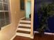 Staircase with wood and white steps, natural light, and a stylish potted plant at 3753 Soapstone Rd, Decatur, GA 30034