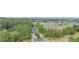 An aerial view of a residential neighborhood with tree-lined streets and well-maintained homes at 4448 Tacoma Trce, Suwanee, GA 30024