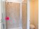 Modern bathroom featuring glass enclosed shower with tile surround and a toilet at 4448 Tacoma Trce, Suwanee, GA 30024
