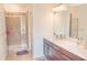 Bright bathroom featuring double sinks and a glass enclosed shower at 4448 Tacoma Trce, Suwanee, GA 30024