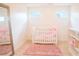 Adorable Bedroom with crib, plush rug, and plenty of natural light, perfect for a new Gathering at 4448 Tacoma Trce, Suwanee, GA 30024