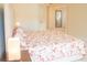 Bright bedroom features carpet, a large bed with a floral pattern, and neutral wall paint at 4448 Tacoma Trce, Suwanee, GA 30024