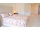 Bright bedroom features carpet, a large bed with a floral pattern, and neutral wall paint at 4448 Tacoma Trce, Suwanee, GA 30024
