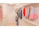 Walk-in closet featuring white built-in shelves and hanging rods for organized storage at 4448 Tacoma Trce, Suwanee, GA 30024