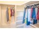 Well-organized walk-in closet with rods and shelves for optimal storage at 4448 Tacoma Trce, Suwanee, GA 30024