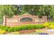 A brick and stone sign welcomes you to the Three Bridges community with a landscape featuring colorful flowers at 4448 Tacoma Trce, Suwanee, GA 30024