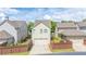 A charming home shows a two-car garage and a small landscaped yard at 4448 Tacoma Trce, Suwanee, GA 30024