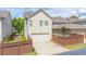 A charming home shows a two-car garage and a small landscaped yard at 4448 Tacoma Trce, Suwanee, GA 30024