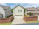 A charming home shows a two-car garage and a small landscaped yard at 4448 Tacoma Trce, Suwanee, GA 30024