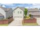 A charming home shows a two-car garage and a small landscaped yard at 4448 Tacoma Trce, Suwanee, GA 30024
