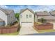 A charming home shows a two-car garage and a small landscaped yard at 4448 Tacoma Trce, Suwanee, GA 30024