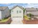 A charming home shows a two-car garage and a small landscaped yard at 4448 Tacoma Trce, Suwanee, GA 30024