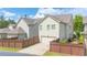 A charming home shows a two-car garage and a small landscaped yard at 4448 Tacoma Trce, Suwanee, GA 30024