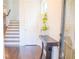 Inviting foyer featuring hardwood floors, staircase, console table, and natural light at 4448 Tacoma Trce, Suwanee, GA 30024