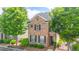 Beautiful two-story brick home featuring mature trees and manicured landscaping at 4448 Tacoma Trce, Suwanee, GA 30024