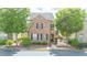 Traditional two-story brick home with black shutters, mature trees and manicured landscaping at 4448 Tacoma Trce, Suwanee, GA 30024