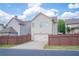 Rear of home featuring a 2-car garage and well-maintained fenced backyard at 4448 Tacoma Trce, Suwanee, GA 30024