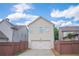 Rear of home featuring a 2-car garage and well-maintained fenced backyard at 4448 Tacoma Trce, Suwanee, GA 30024