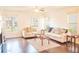 Bright living room with hardwood floors and large windows, offering a comfortable space at 4448 Tacoma Trce, Suwanee, GA 30024