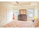 Spacious main bedroom with tray ceiling, neutral walls, and a cozy sitting area at 4448 Tacoma Trce, Suwanee, GA 30024