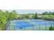 A view of the tennis courts with blue playing surface surrounded by a dark fence in a community setting at 4448 Tacoma Trce, Suwanee, GA 30024
