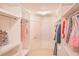 Spacious walk-in closet with custom shelving and ample storage for clothes and accessories at 4448 Tacoma Trce, Suwanee, GA 30024