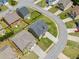 An aerial view capturing a home's setting within a neighborhood featuring mature trees and manicured lawns at 4920 Fourth Rail Ln, Cumming, GA 30040
