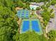 Aerial view of community amenities that include tennis courts, a playground, and a pool at 4920 Fourth Rail Ln, Cumming, GA 30040