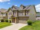 Traditional home with stone and siding exterior, complemented by lush greenery at 4920 Fourth Rail Ln, Cumming, GA 30040