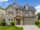 Two-story home boasts a stone facade, muted siding, and a well-manicured lawn at 4920 Fourth Rail Ln, Cumming, GA 30040
