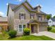 Charming home features stone accents, neutral siding, and a two-car garage at 4920 Fourth Rail Ln, Cumming, GA 30040