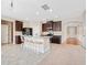 Well-equipped kitchen with granite counters, dark cabinetry and island with barstool seating at 4920 Fourth Rail Ln, Cumming, GA 30040