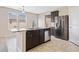 Bright kitchen with island, stainless appliances, stone countertops and eat-in bar at 4920 Fourth Rail Ln, Cumming, GA 30040